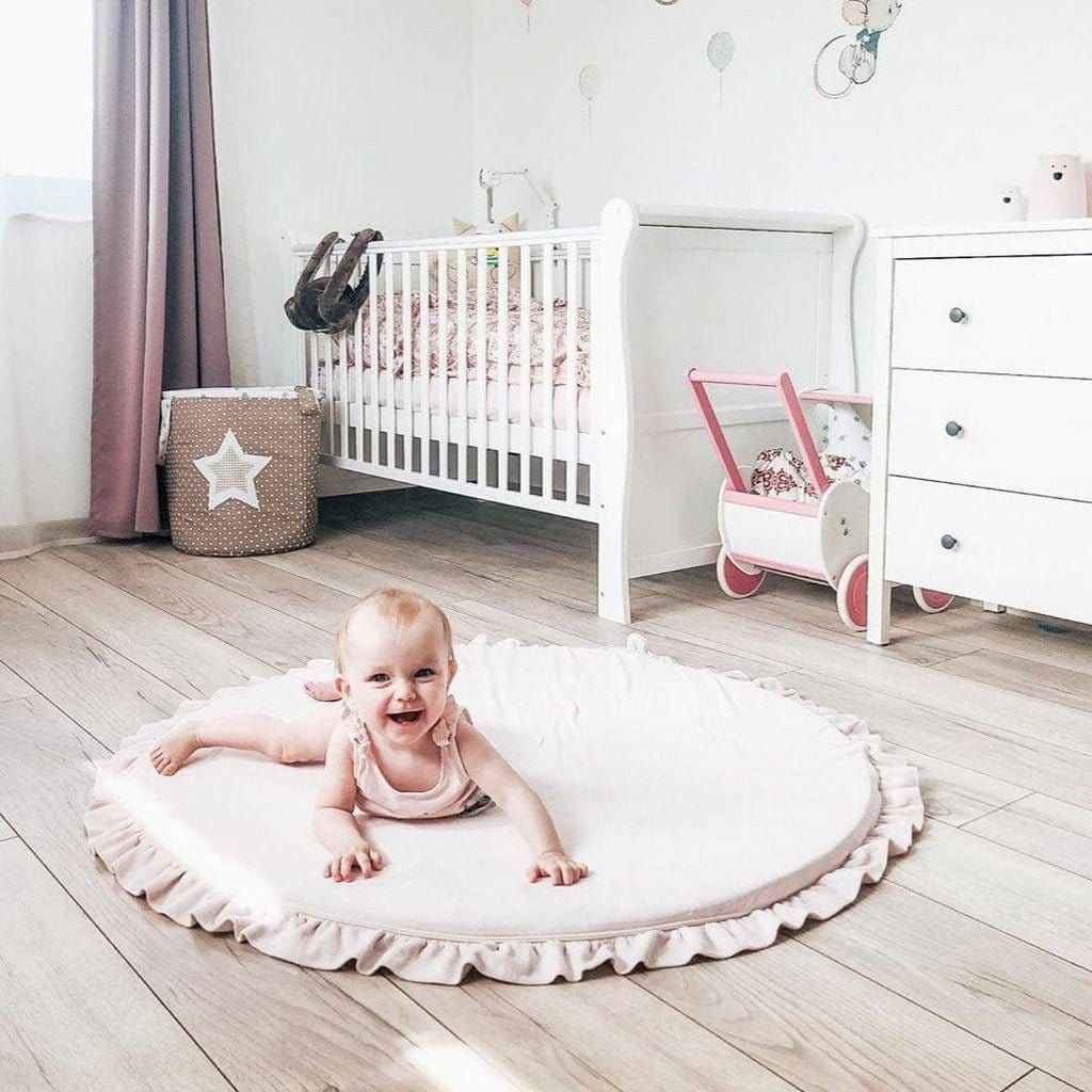 baby lying on Meow Baby Round Fill Baby Play Mat in bedroom floor