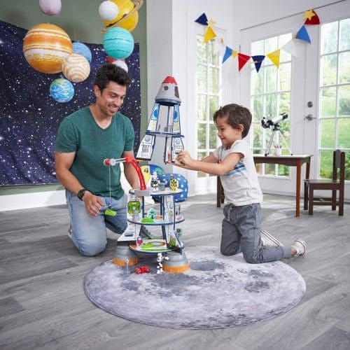 man and boy playing with KidKraft Rocket Ship Play Set