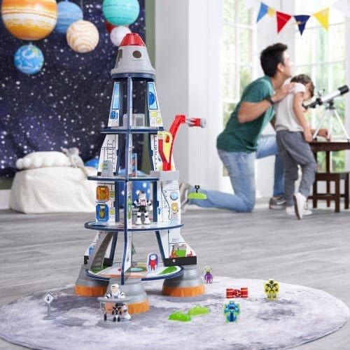 man and boy looking through telescope with KidKraft Rocket Ship Play Set in front