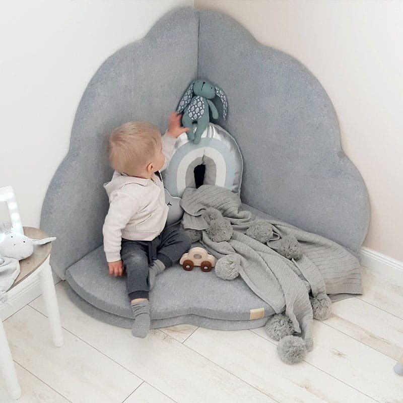 boy sitting on Meow Baby Cloud Shaped Foldable Baby Play Mat in corner of room