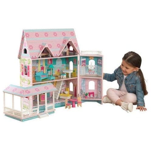 girl playing with KidKraft Abbey Manor Dollhouse