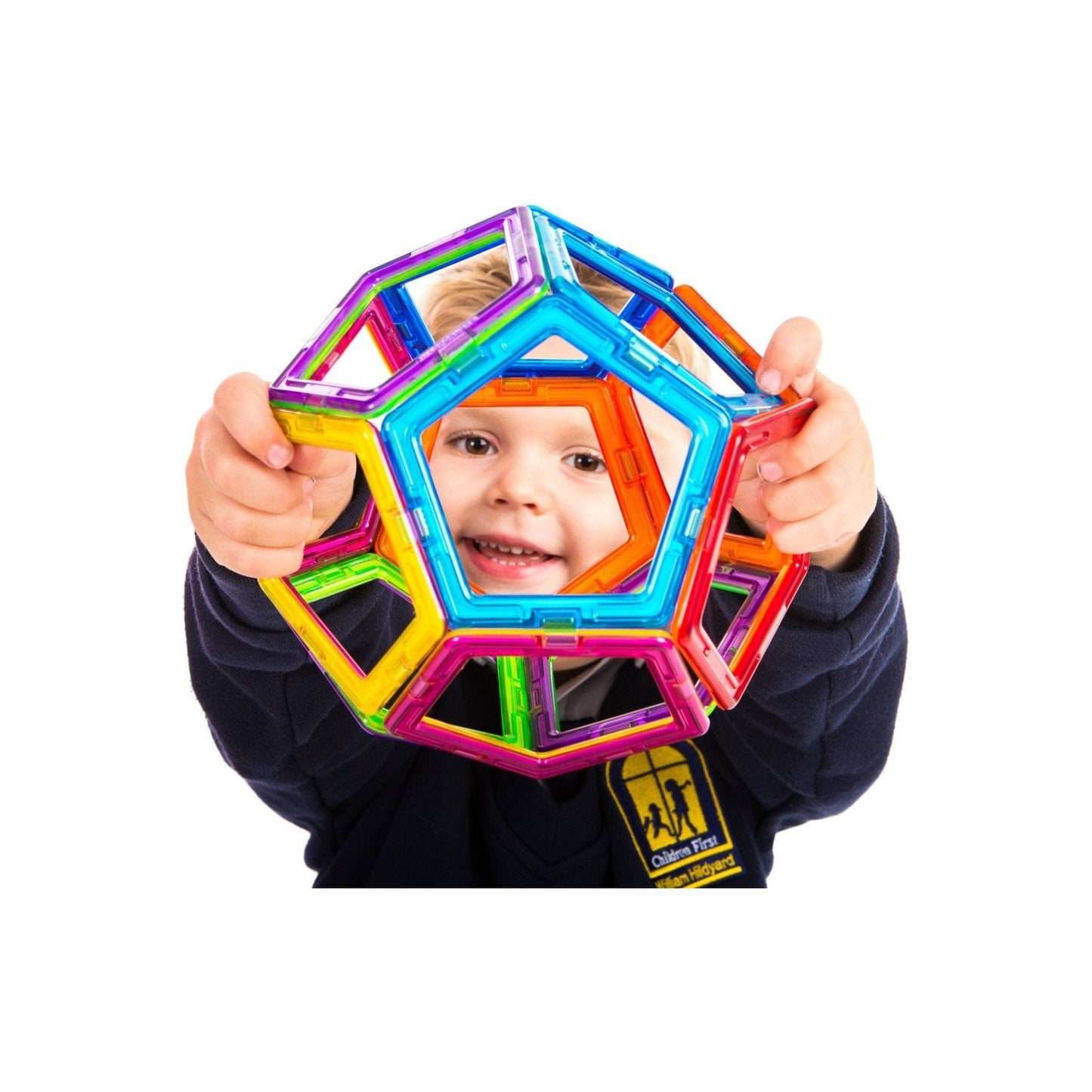 child holding shape made from Magformers construction toy 62 Piece Set