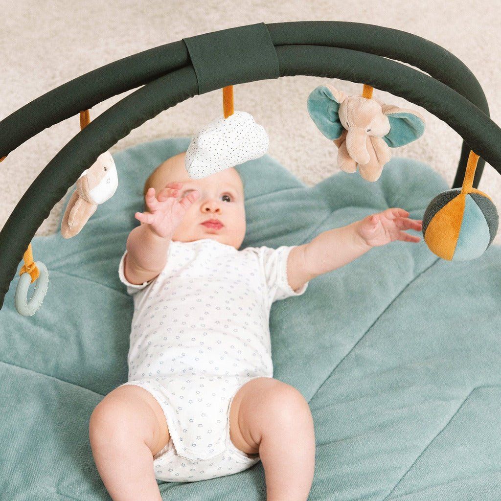 baby reaching for haning toys on Nattou Baby Playmat - Luna and Axel