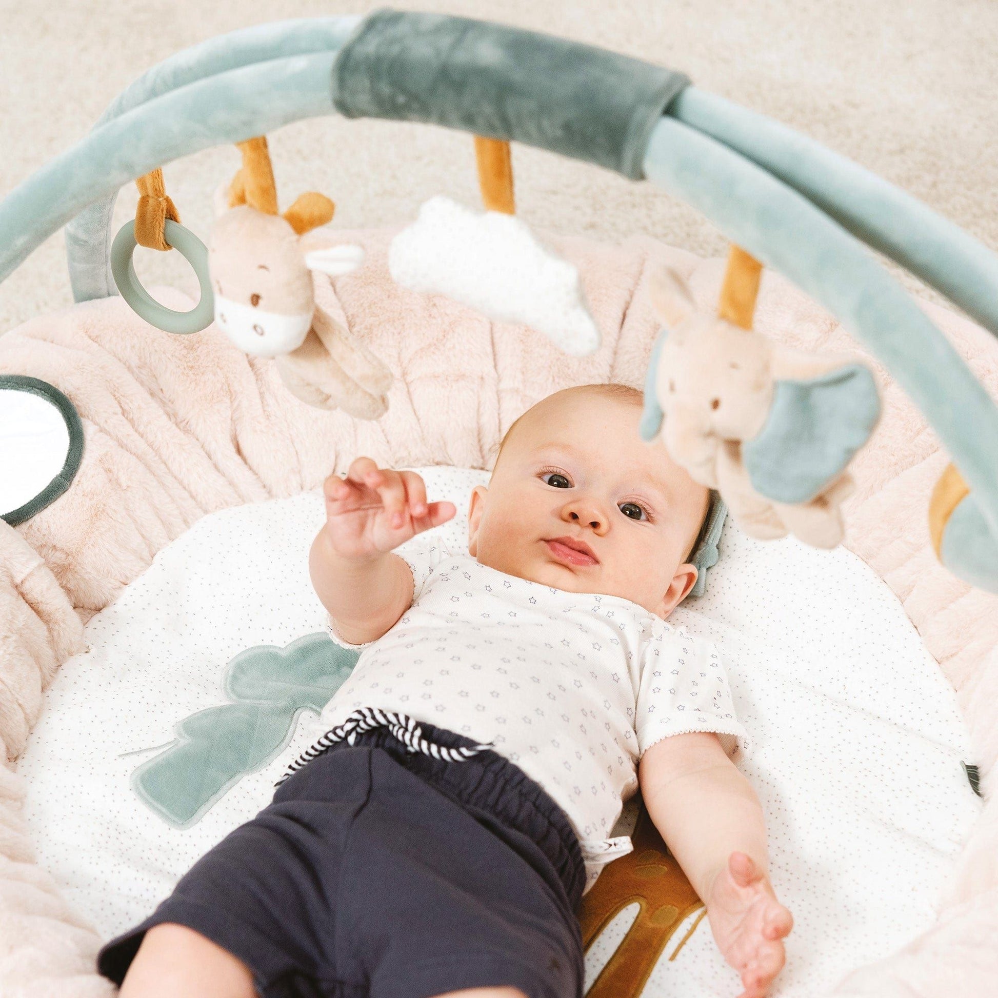 baby lying on Nattou Baby Stuffed Playmat - Luna and Axel