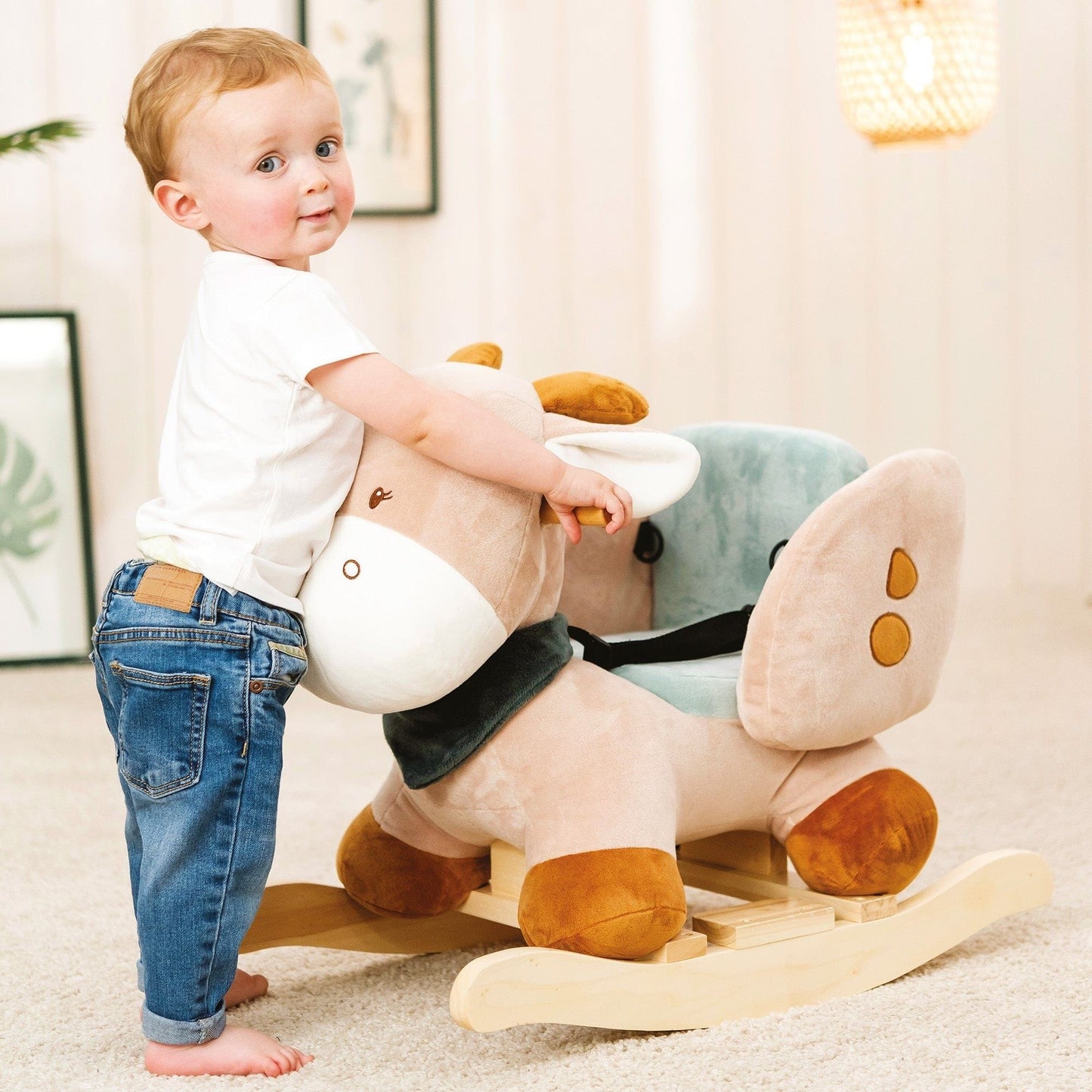 little boy standing next to Nattou Baby Rocker - Luna the Giraffe