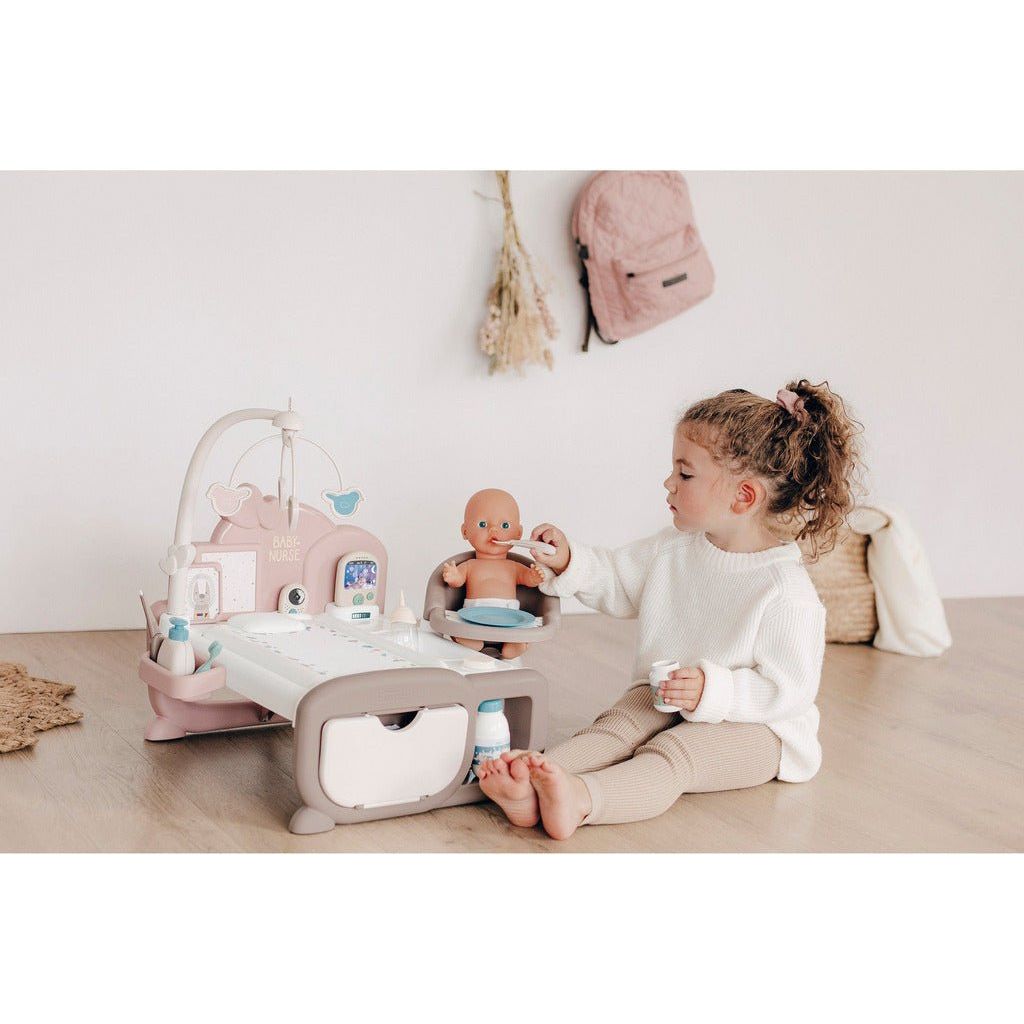 girl feeding doll at Smoby Baby Nurse 3 in 1 Electronic Nursery