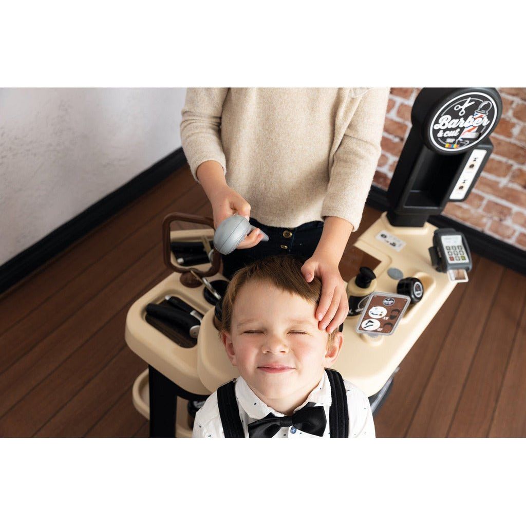 boy having hair washed in Smoby Barber Shop