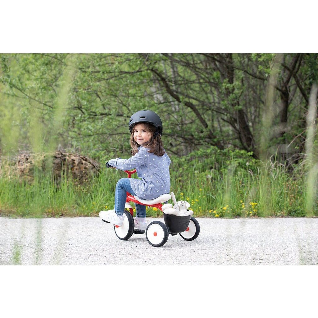 little girl riding Smoby Rookie Tricycle outside
