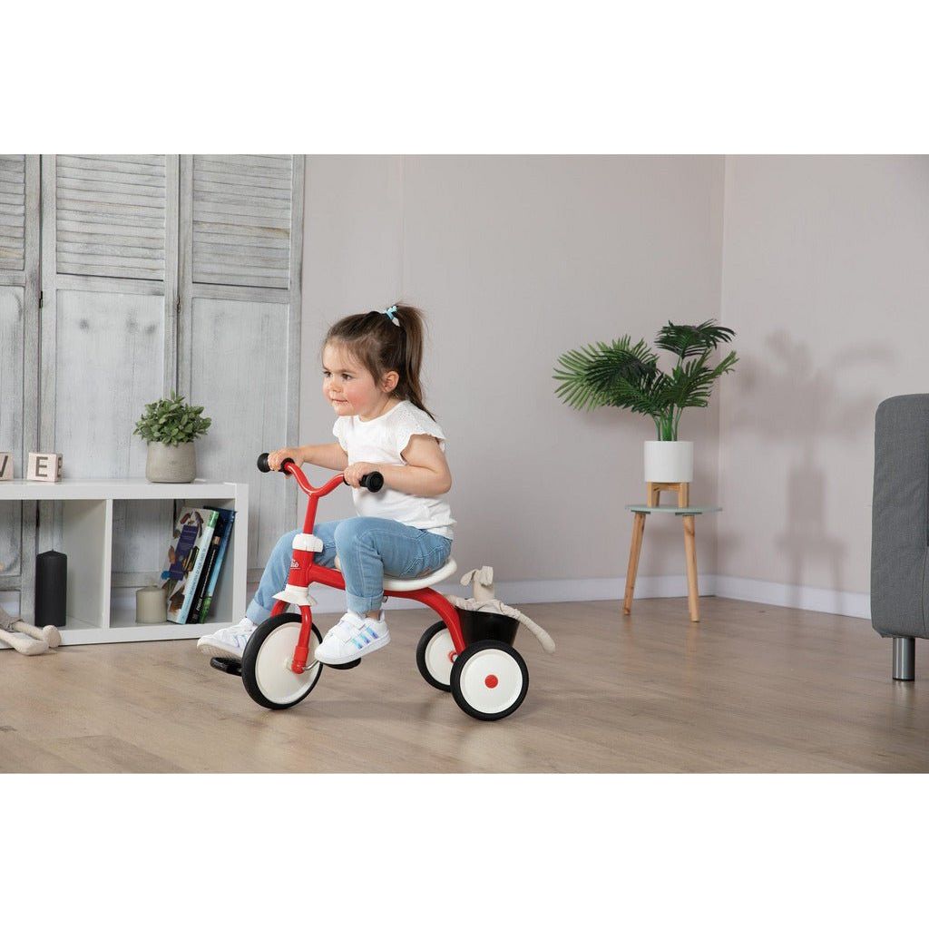 girl riding Smoby Rookie Tricycle  indoors