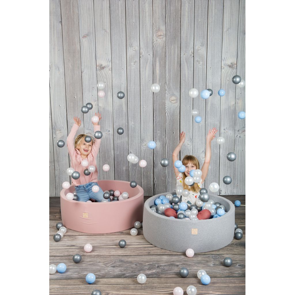 2 girls sitting in Misioo Joy Cotton Ball Pits in blue and Pink and throwing 200 Grey and White Balls in the air