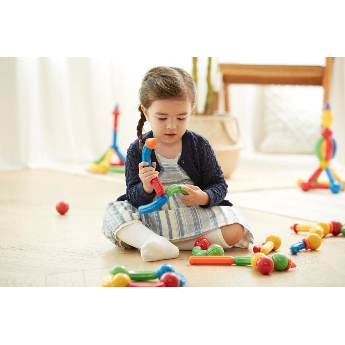 girl playing with Magformers Stick-O Basic 30 Piece Set 