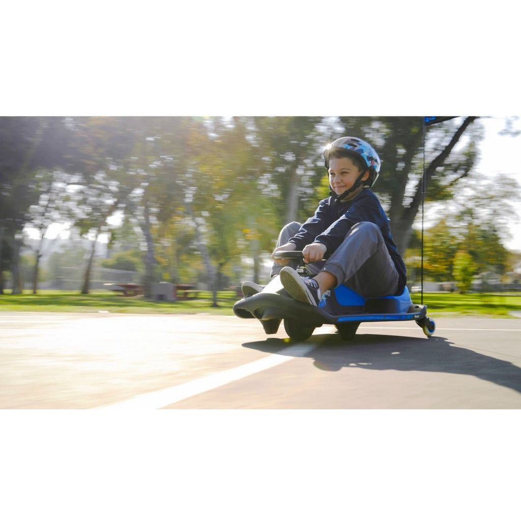 boy in helmet riding Razor Crazy Cart Shift 12 Volt
