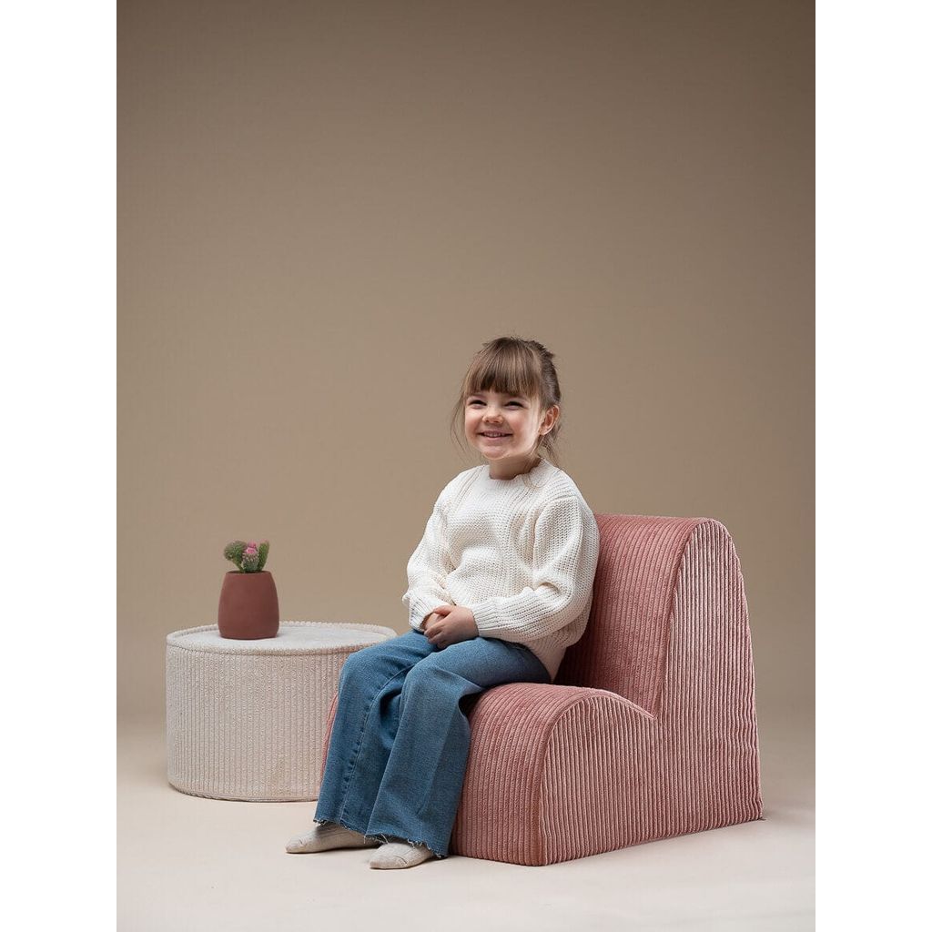 girl sitting on Wigiwama Pink Mousse Kids Cloud Chair