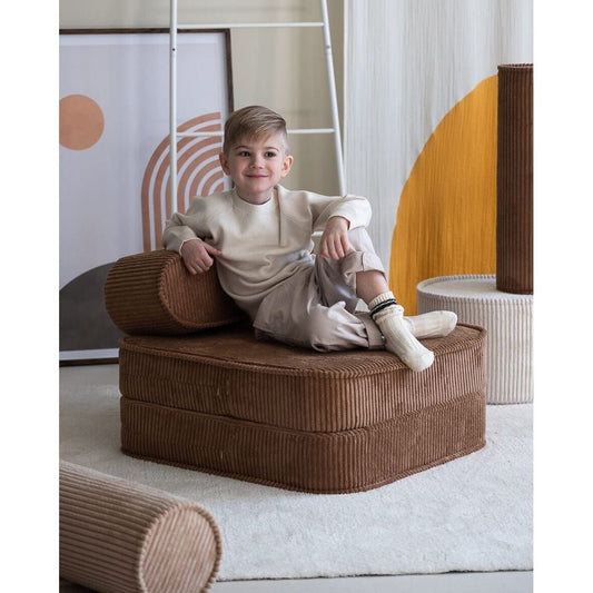 boy sitting on Wigiwama Toffee Flip Chair kids furniture