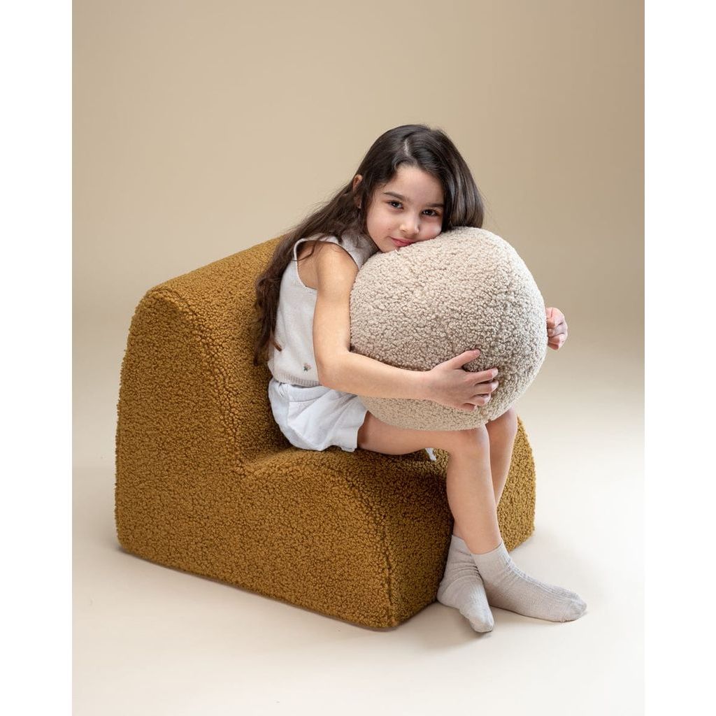 girl sitting on Wigiwama Maple Cloud Chair with face resting on ball cushion