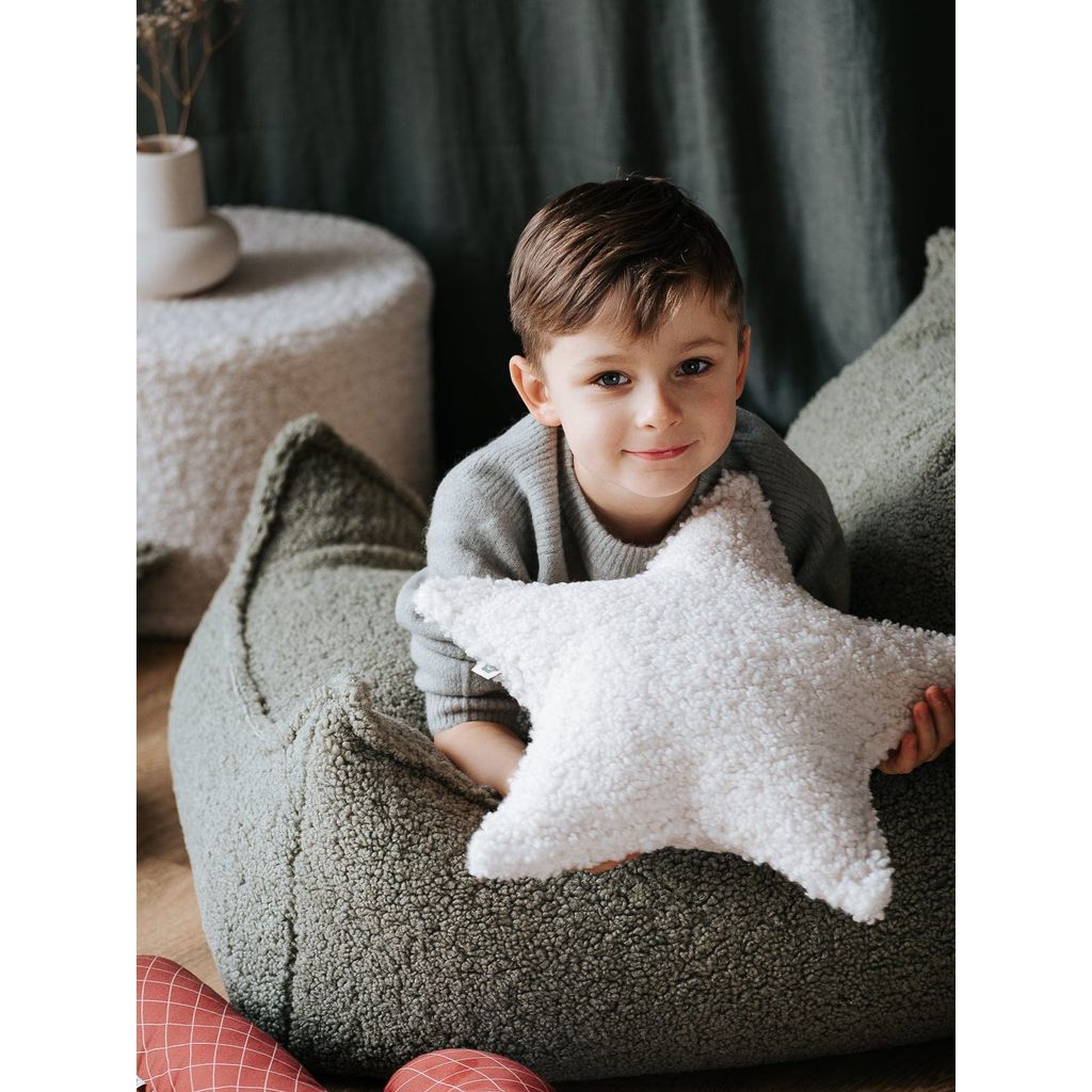 boy lying on beanbag chair and holding Wigiwama Cream White Star Cushion