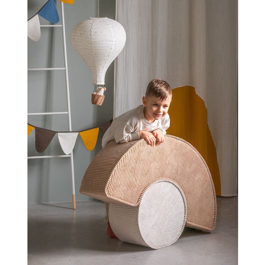 boy leaning over Wigiwama Brown Sugar Pouffe Set