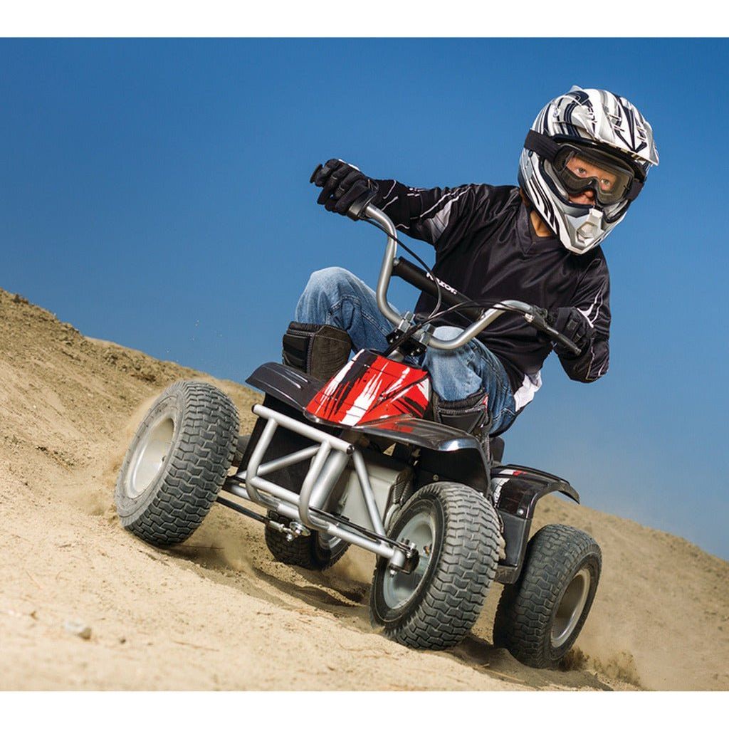 boy in helmet riding Razor Quad Bike 24 Volt - Black on dirt