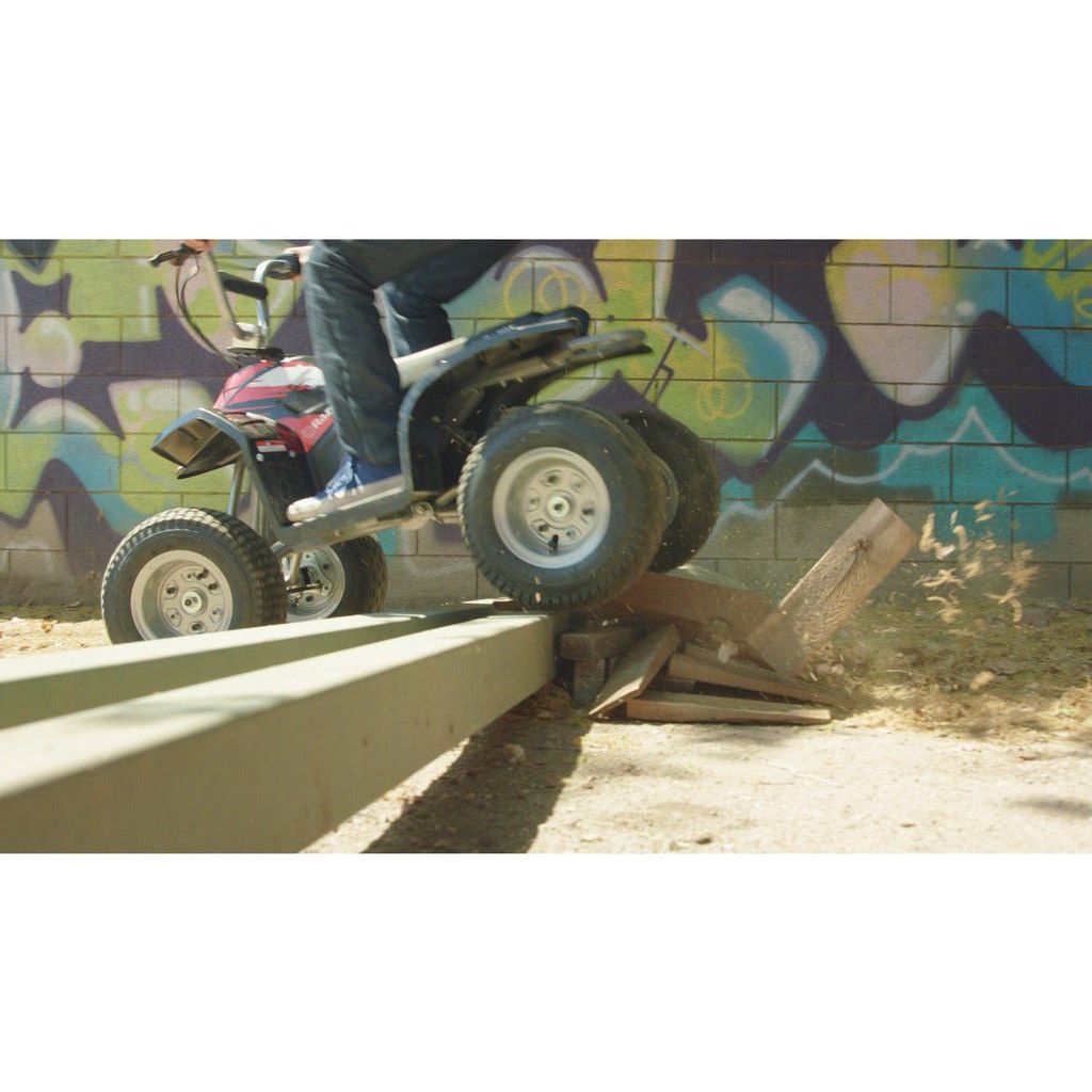 Razor Quad Bike 24 Volt - Black driving over obstacles