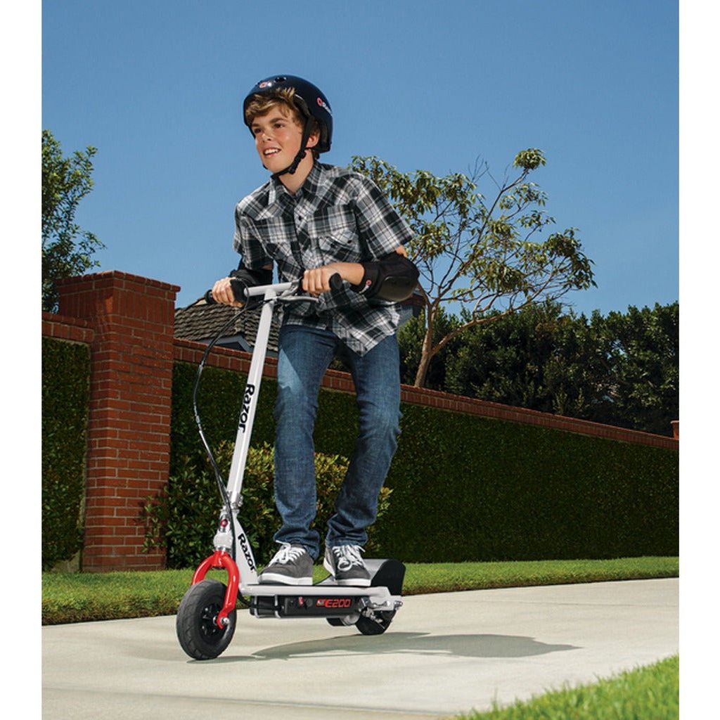 boy crocuhing while riding Razor E200 12 Volt Scooter