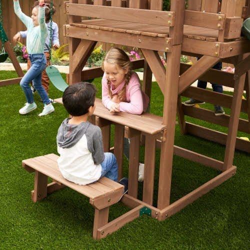 boy and girl on bench of KidKraft Arbor Crest Deluxe Playset