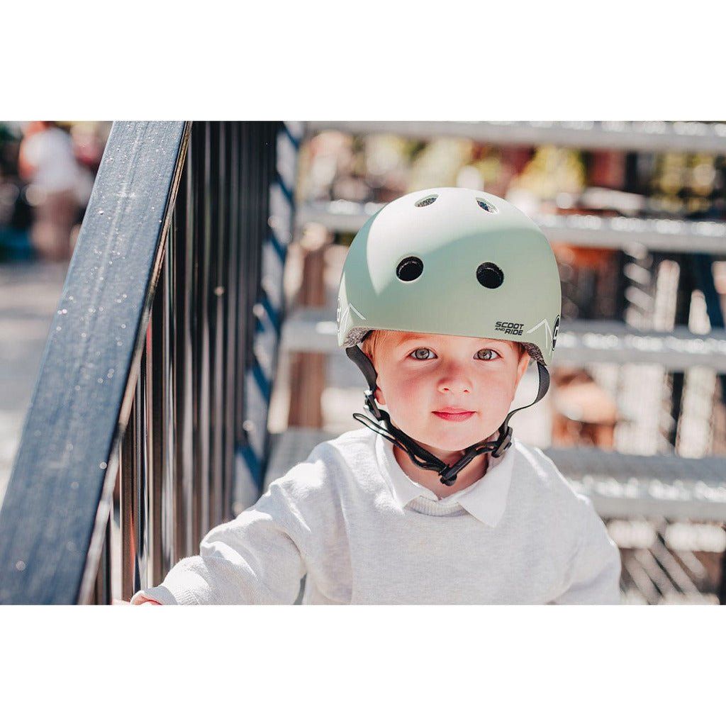 little boy wearing Scoot and Ride Helmet - XXS - S - Green Lines