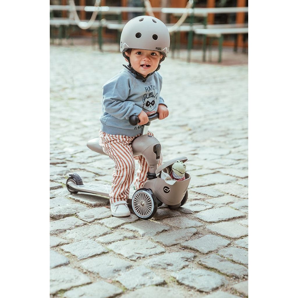 child sitting onScoot and Ride Highwaykick 1 Lifestyle Scooter- Brown Lines 
