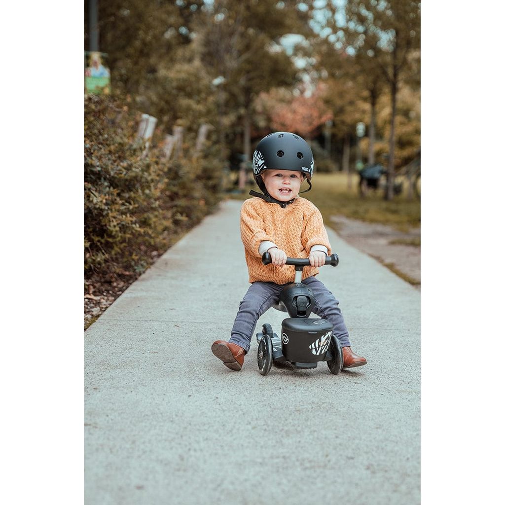 child sitting on seated Scoot and Ride Highwaykick 1 Lifestyle Scooter - Zebra 