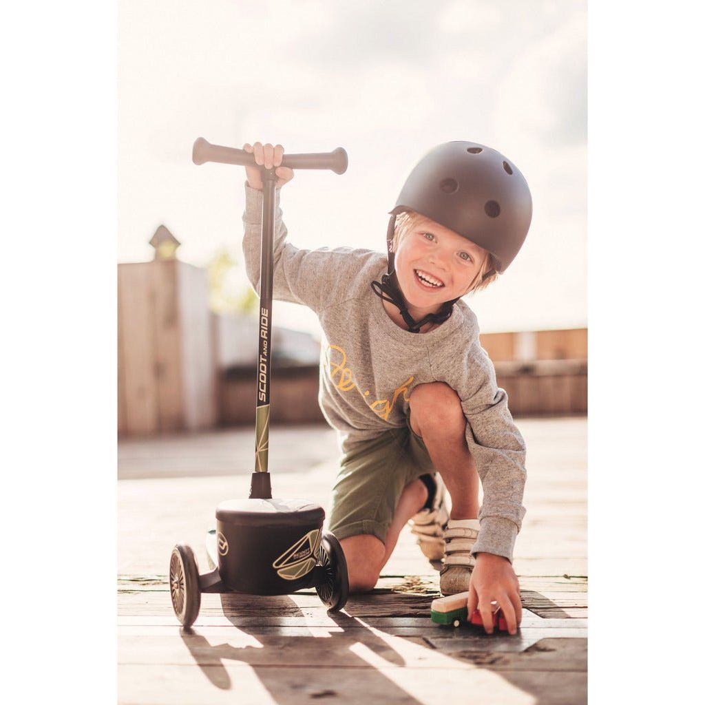 smiling boy kneeling with Scoot and Ride Highwaykick 2 - Age 2+ - Green Lines