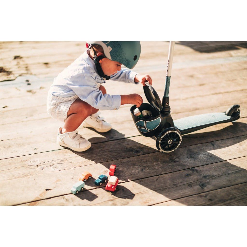 littkle boy putting toys in storage box of Scoot and Ride Highwaykick 2 Lifestyle - Age 2+ - Reflect Steel