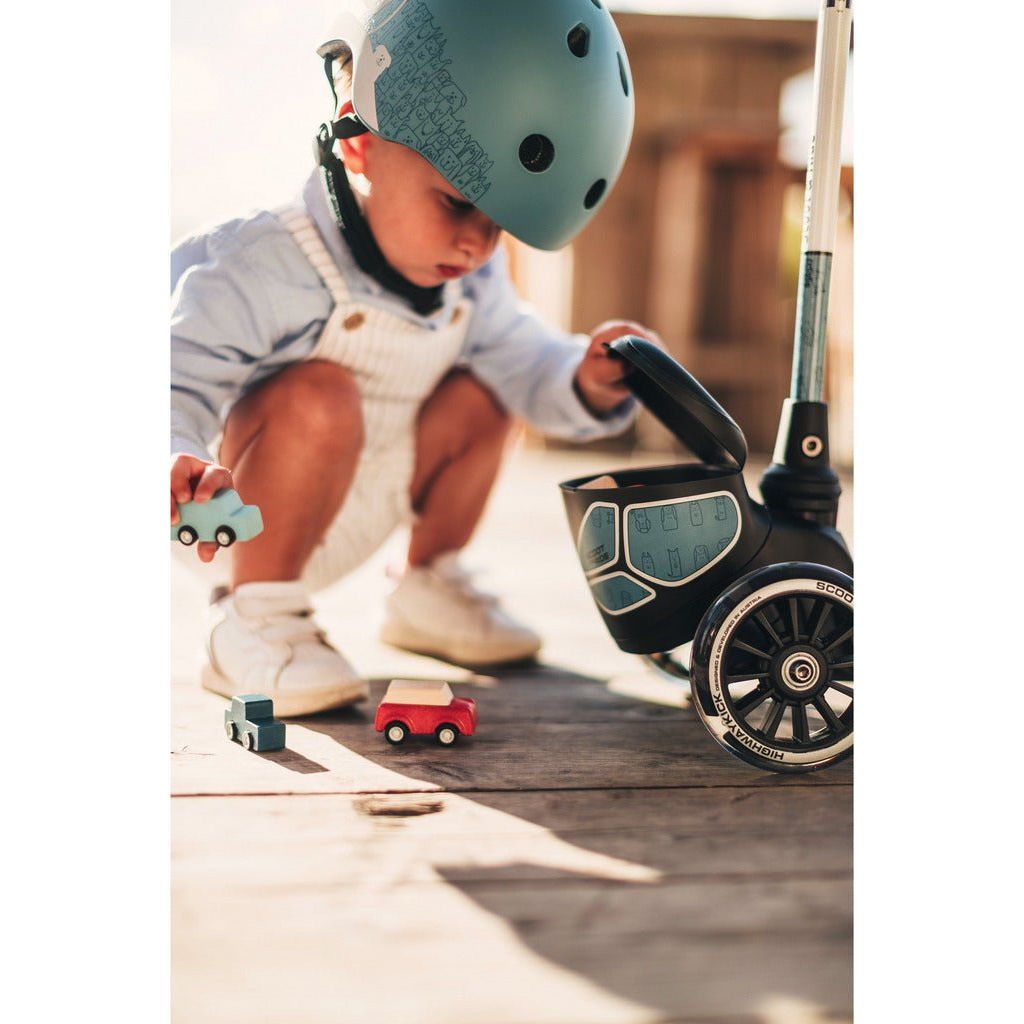 little boy kneeling nect to Scoot and Ride Highwaykick 2 Lifestyle - Age 2+ - Reflect Steel