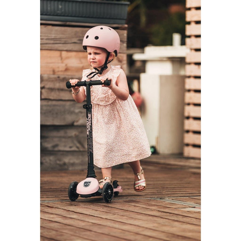 little girl in helmet riding Scoot and Ride Highwaykick 3 Scooter - Age 3+ - Led Rose