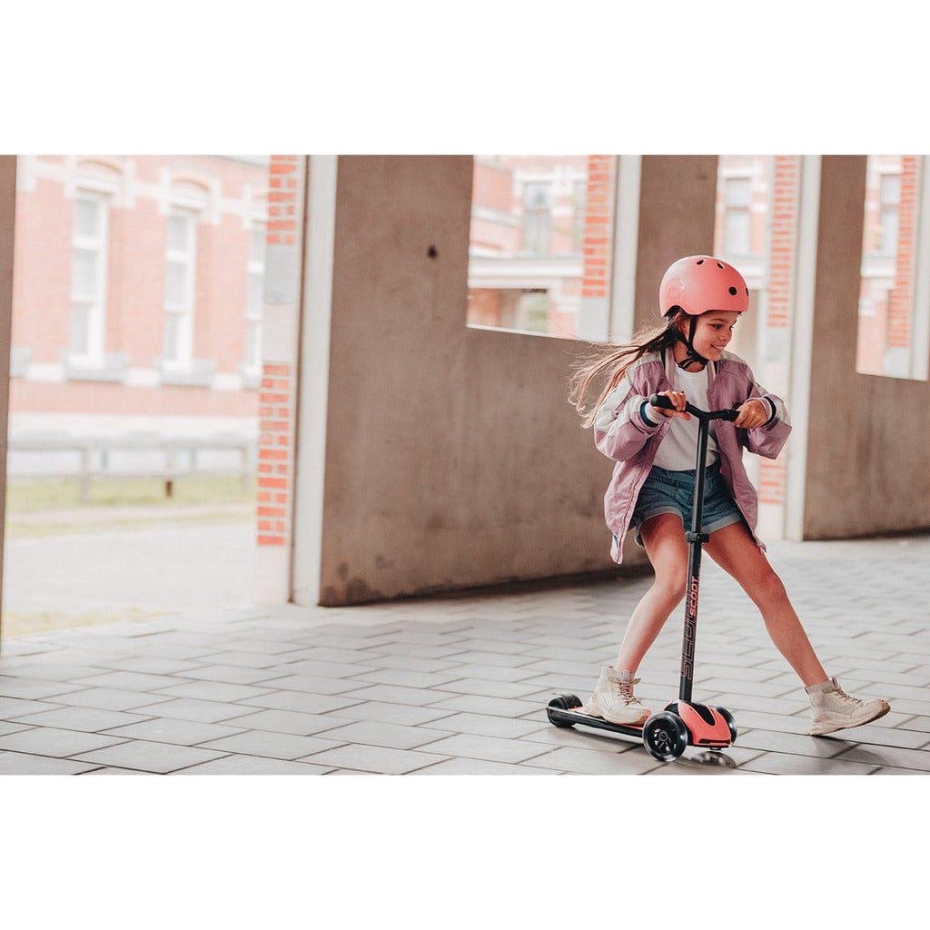 girl riding Scoot and Ride Highwaykick 5 Scooter - Led Peach