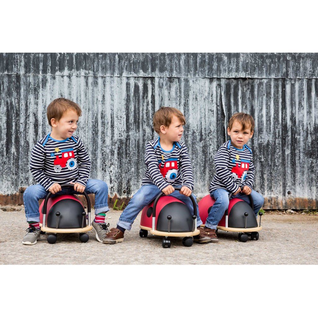 three boys sitting on Wheelybug ladybird Ride Ons