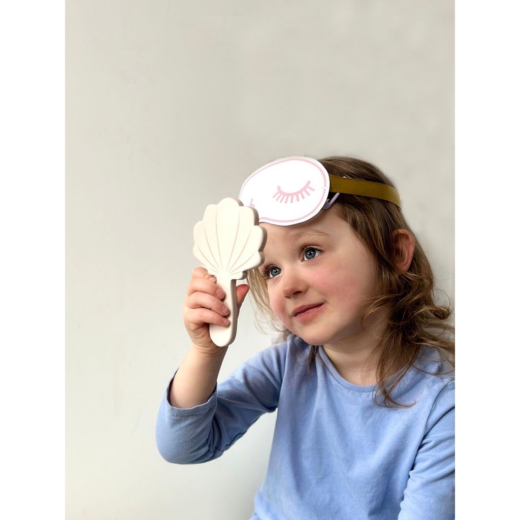girl with eye mask from Tender Leaf Wooden Toy Spa Retreat Set  looking in mirror