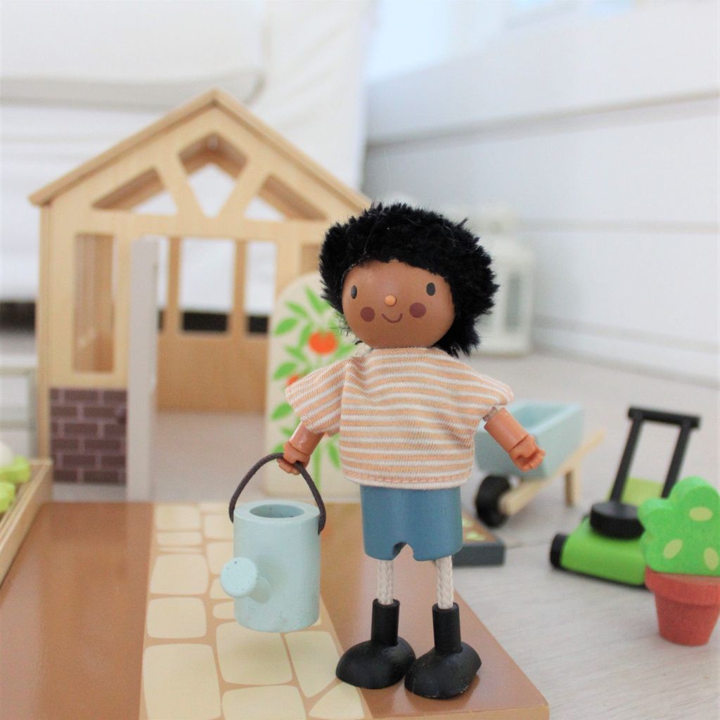 character with watering can from Tender Leaf Wooden Greenhouse & Garden Set close up