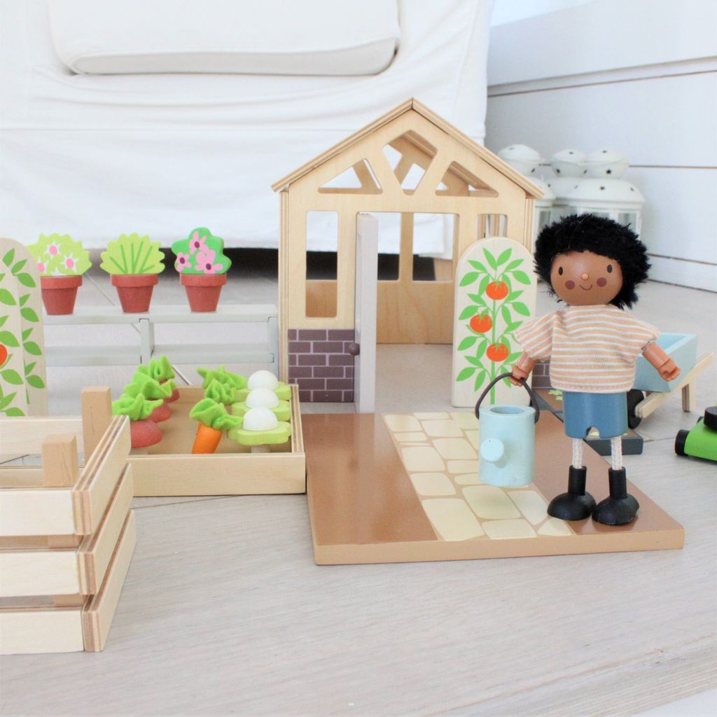 character with watering can from Tender Leaf Wooden Greenhouse & Garden toy Set