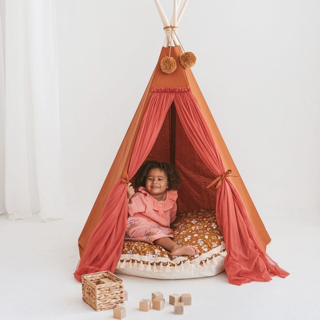 girl lying on cushion inside MINICAMP Fairy Kids Play Tent With Tulle in Cognac