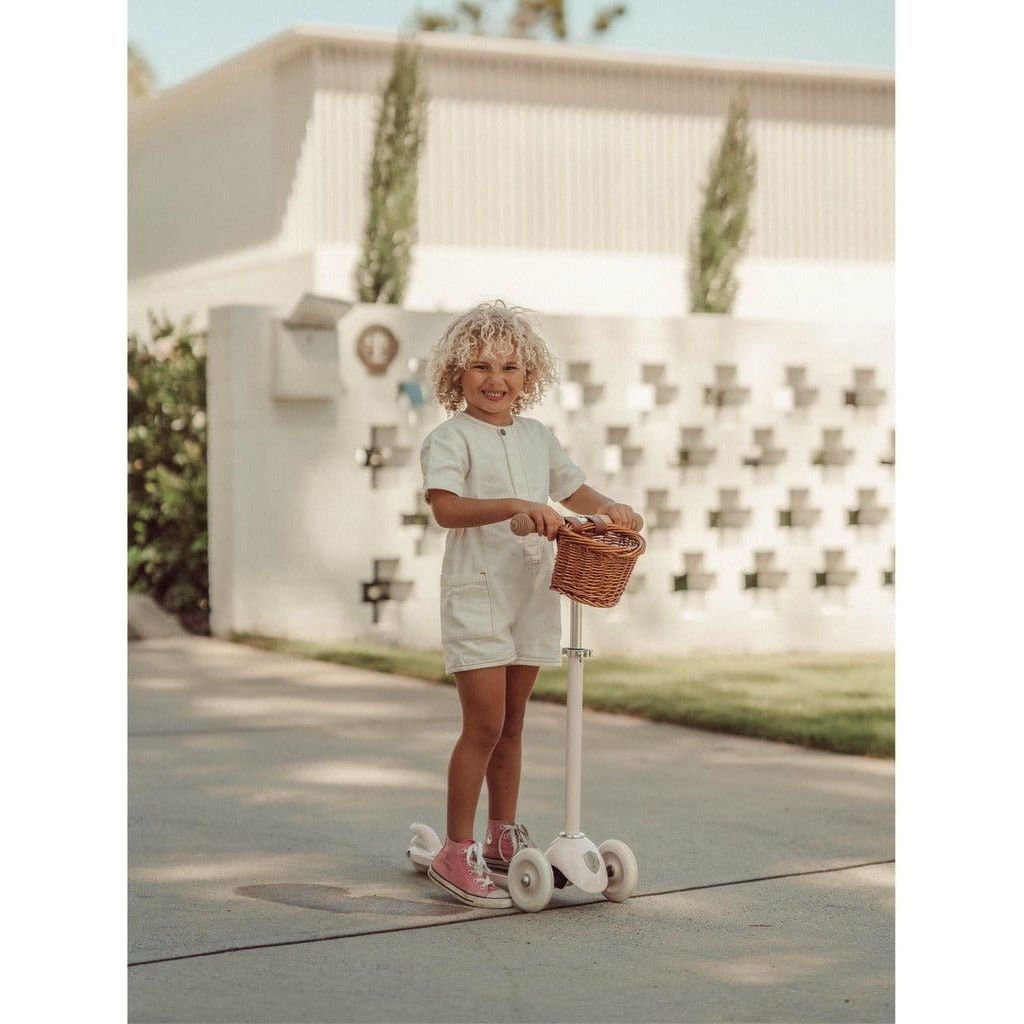 Child standing with Banwood Scooter Age 3+ in White outside house