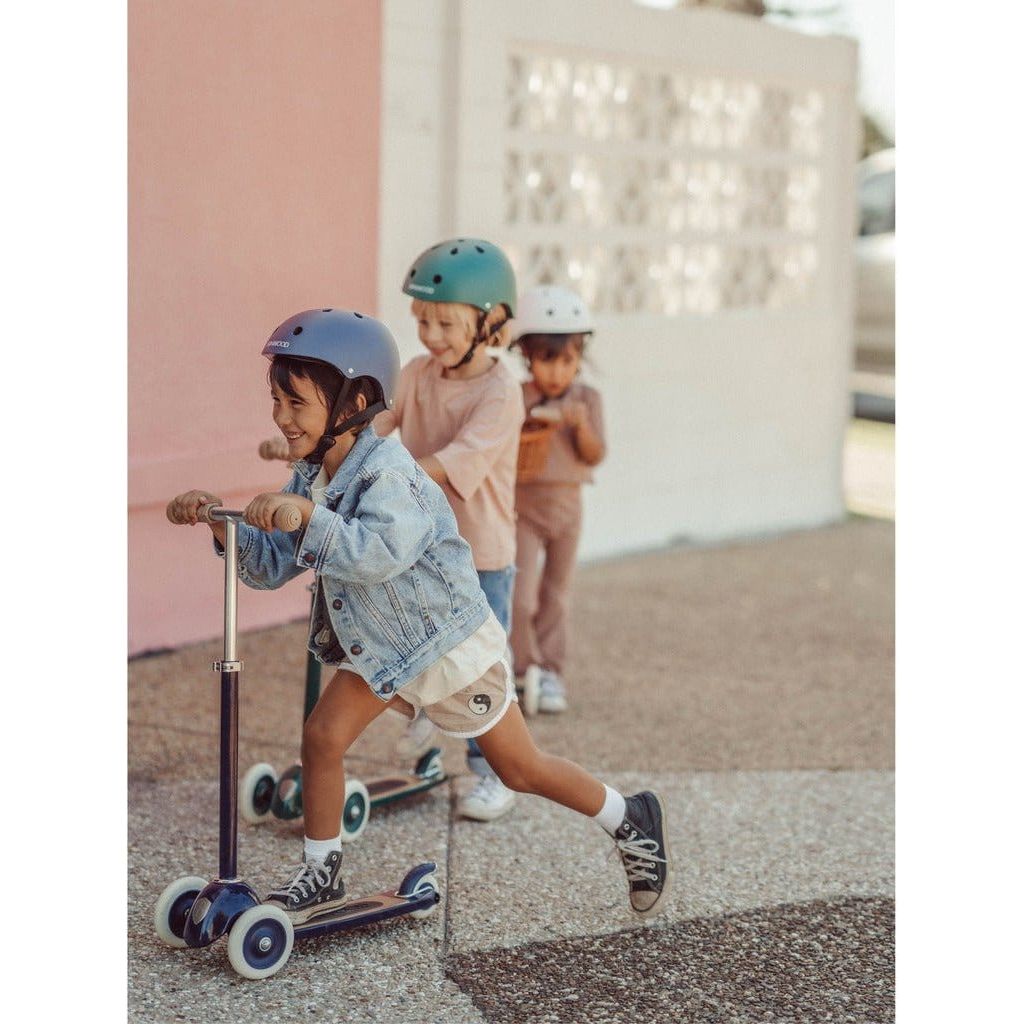 Little girl riding Banwood Scooter Age 3+ in Navy Blue