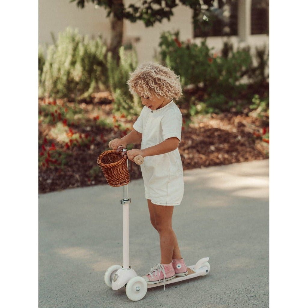 Child riding Banwood Scooter Age 3+ in White on pavement