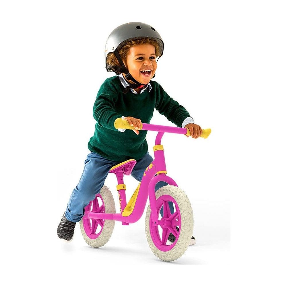 little boy riding Chillafish Charlie Balance Bike 18M-4Y in Pink