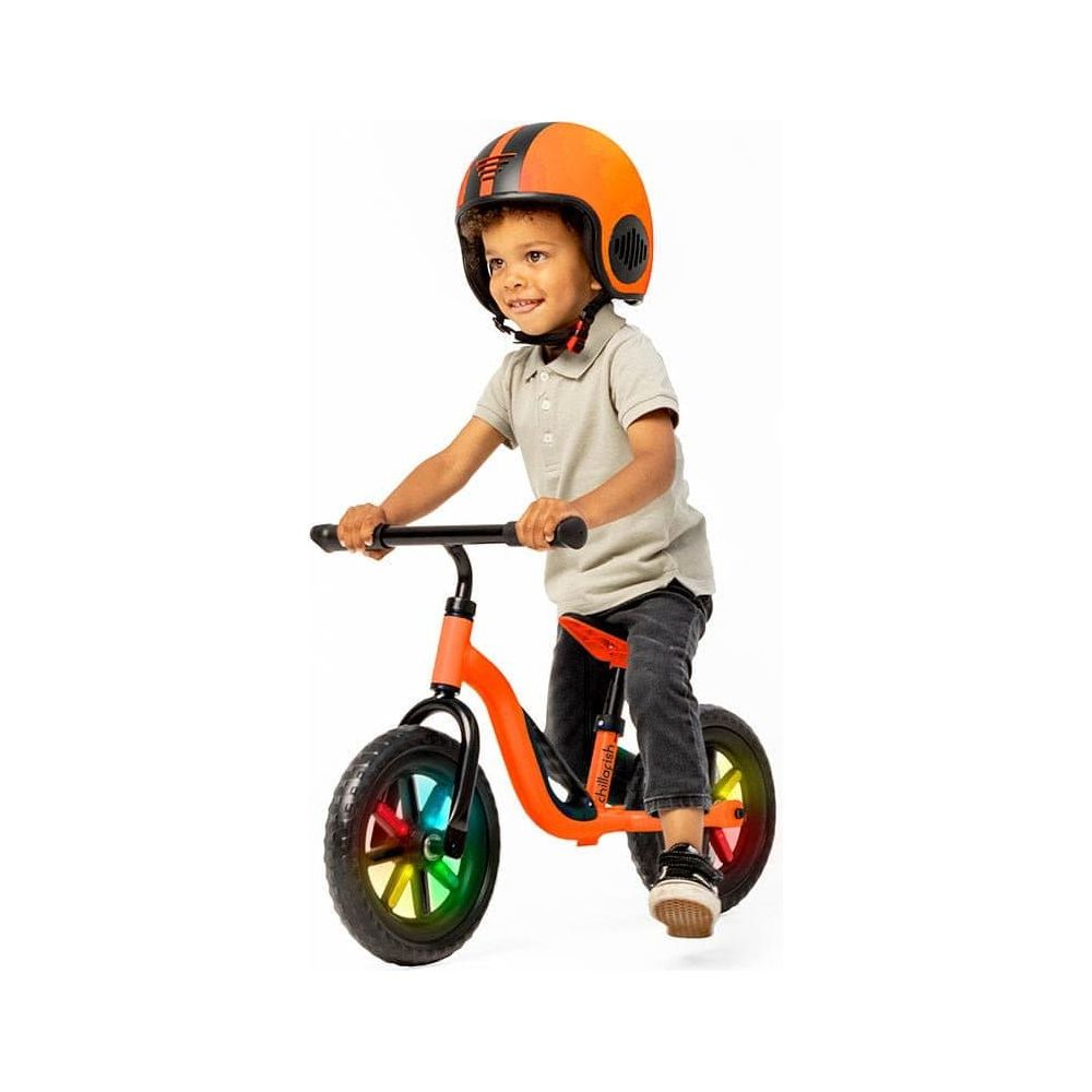 boy riding Chillafish Charlie Glow Balance Bike 18M-4Y in Orange
