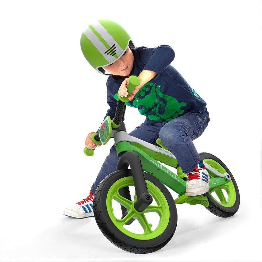 Little boy wearing helmet and riding Chillafish Bmxie Balance Bike 2-5 Years in Lime Green