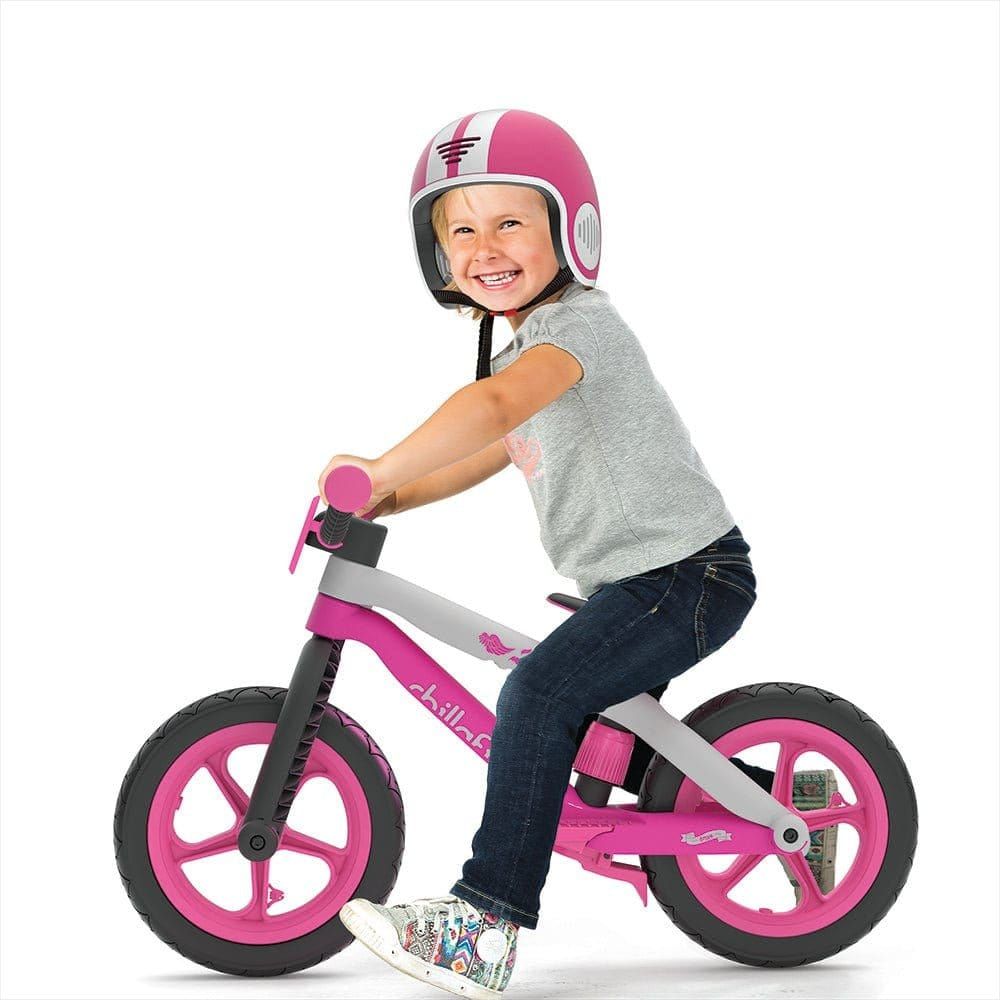 Little boy wearing Chillafish helmet and riding Bmxie Balance Bike 2-5 Years in Pink 