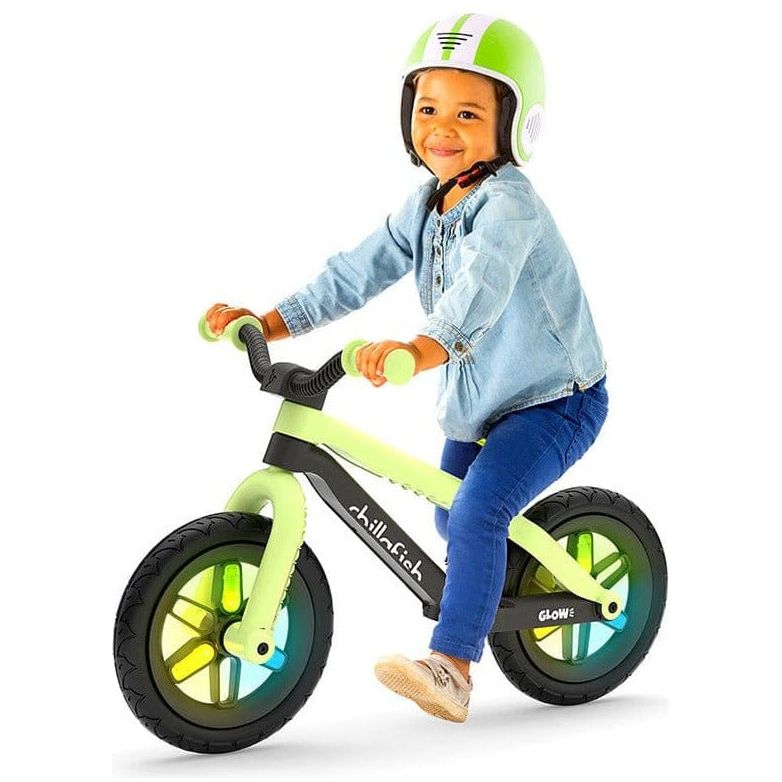 Little boy riding Chillafish Bmxie Glow Balance Bike 2-5 Years in Pistachio Green and wearing green Chillafish helmet