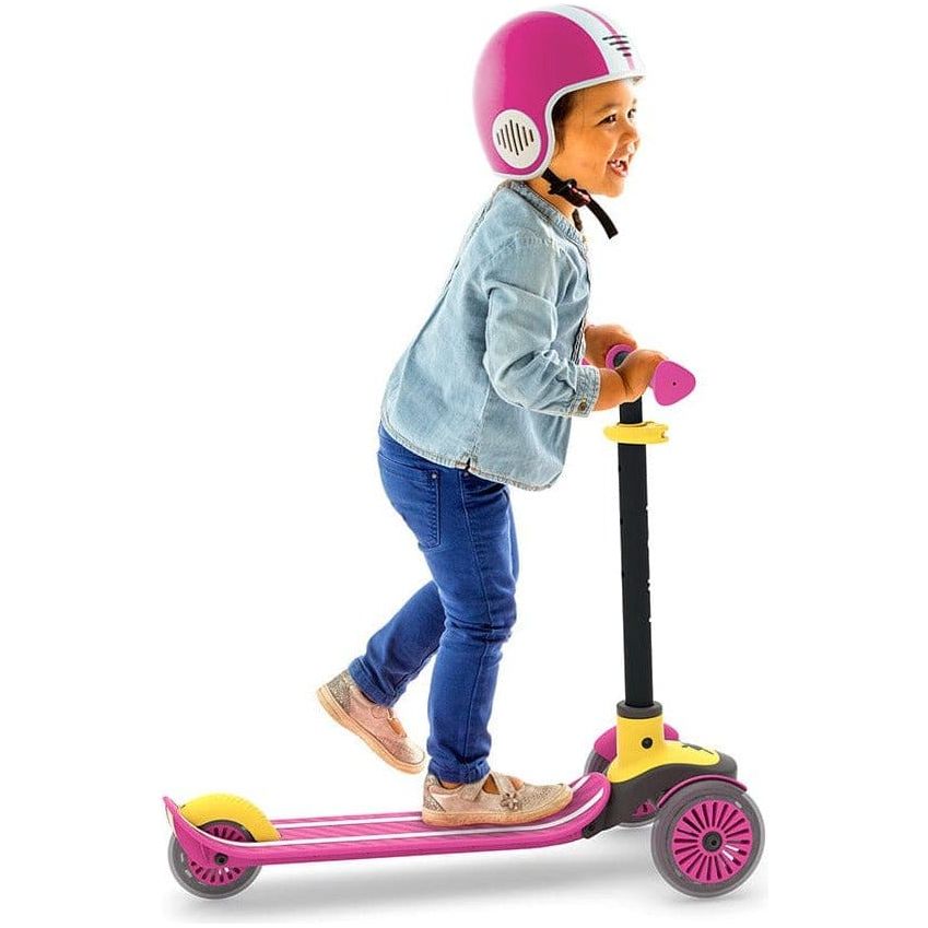 boy in helmet riding Chillafish Scotti Scooter in Pink side