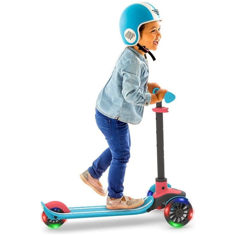boy in helmet riding Chillafish Scotti Glow Scooter with light up wheels in Blue