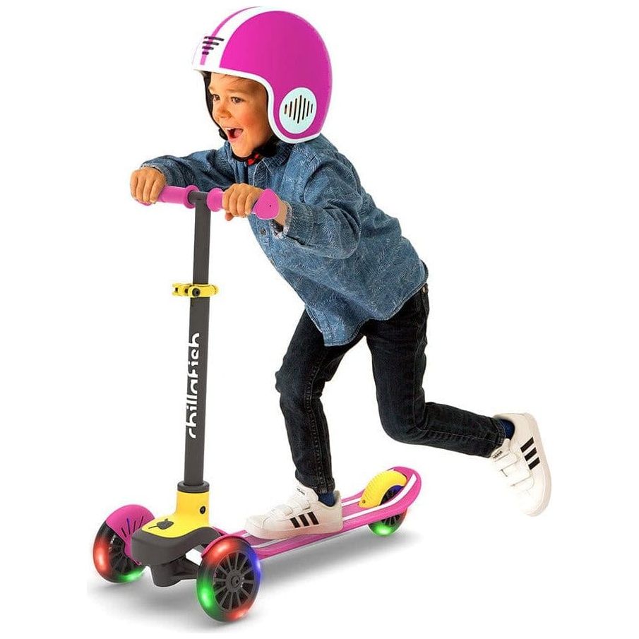 boy in helmet riding Chillafish Scotti Glow Scooter in Pink with light up wheels