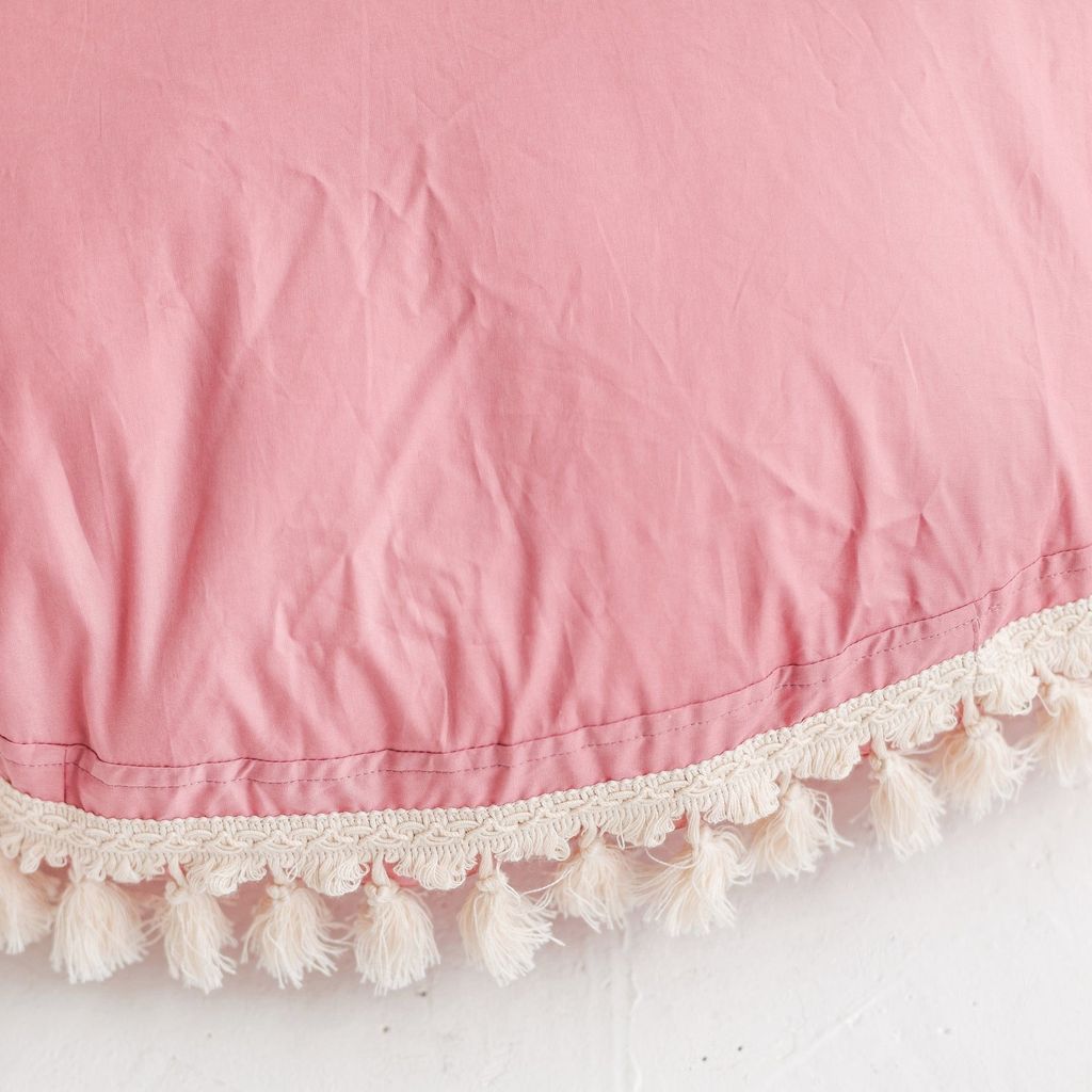 close up of MINICAMP Large Floor Cushion Tassels in Rose